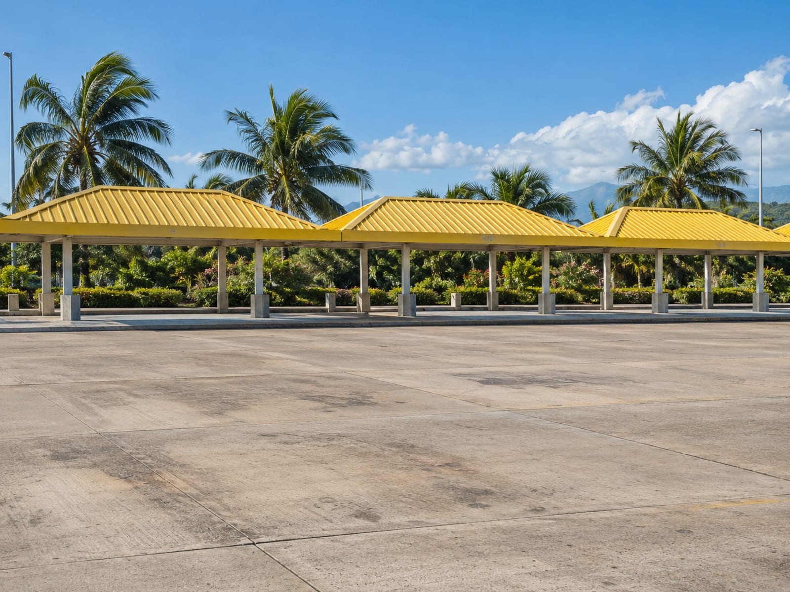 A taxi stand kerb at a Caribbean airport seen from a distance