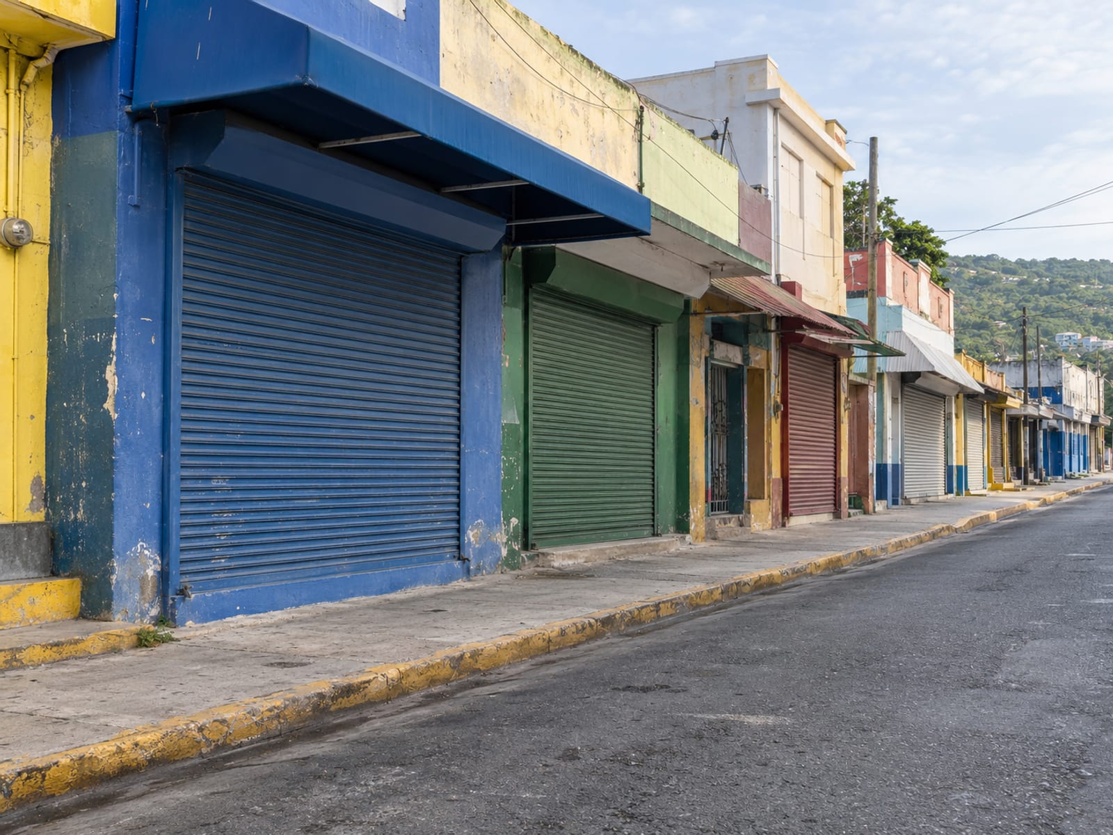 Quiet town street on a holiday morning with shop shutters down and no traffic