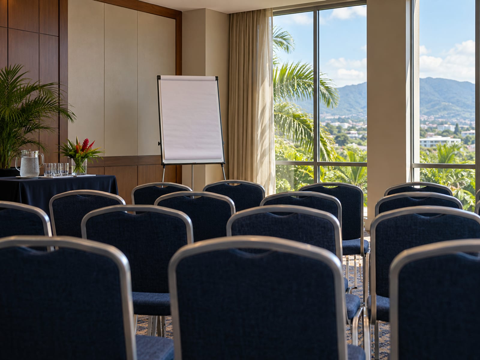 Empty conference room with rows of chairs, a blank flip chart and a window