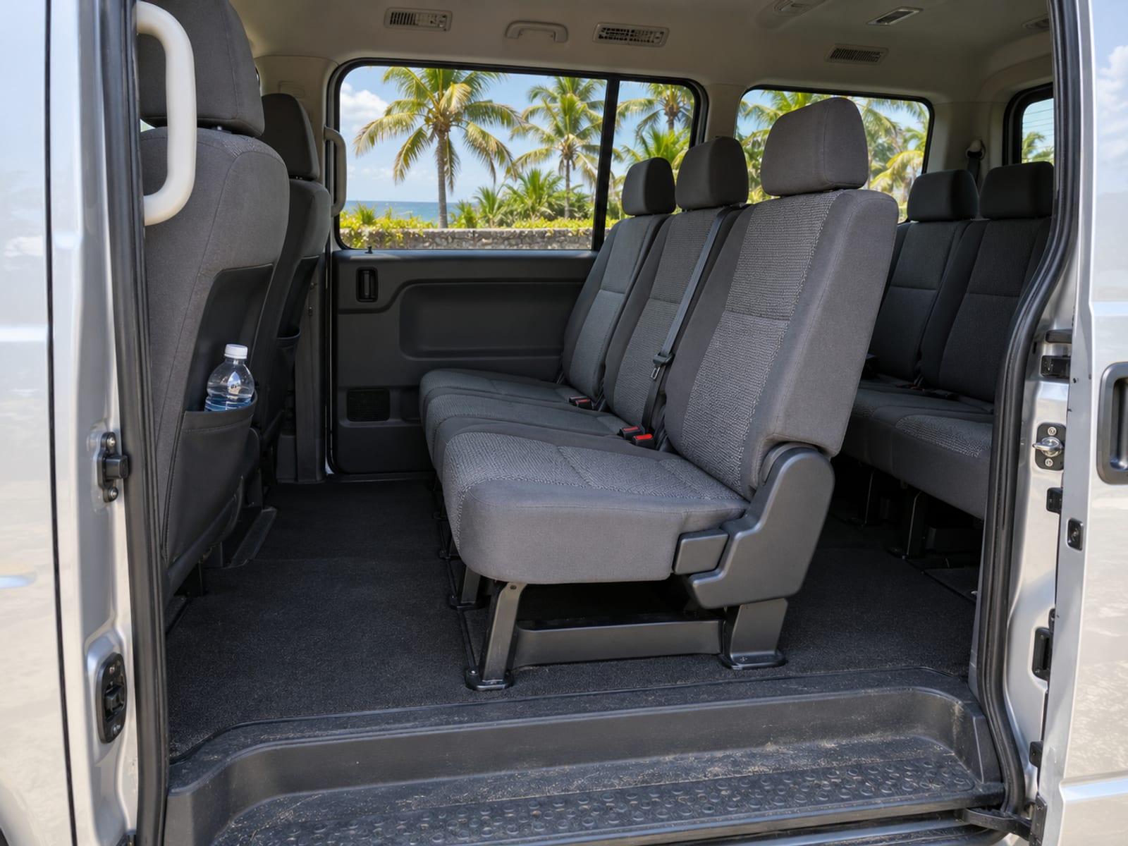 The clean interior of a passenger van seen through its open door