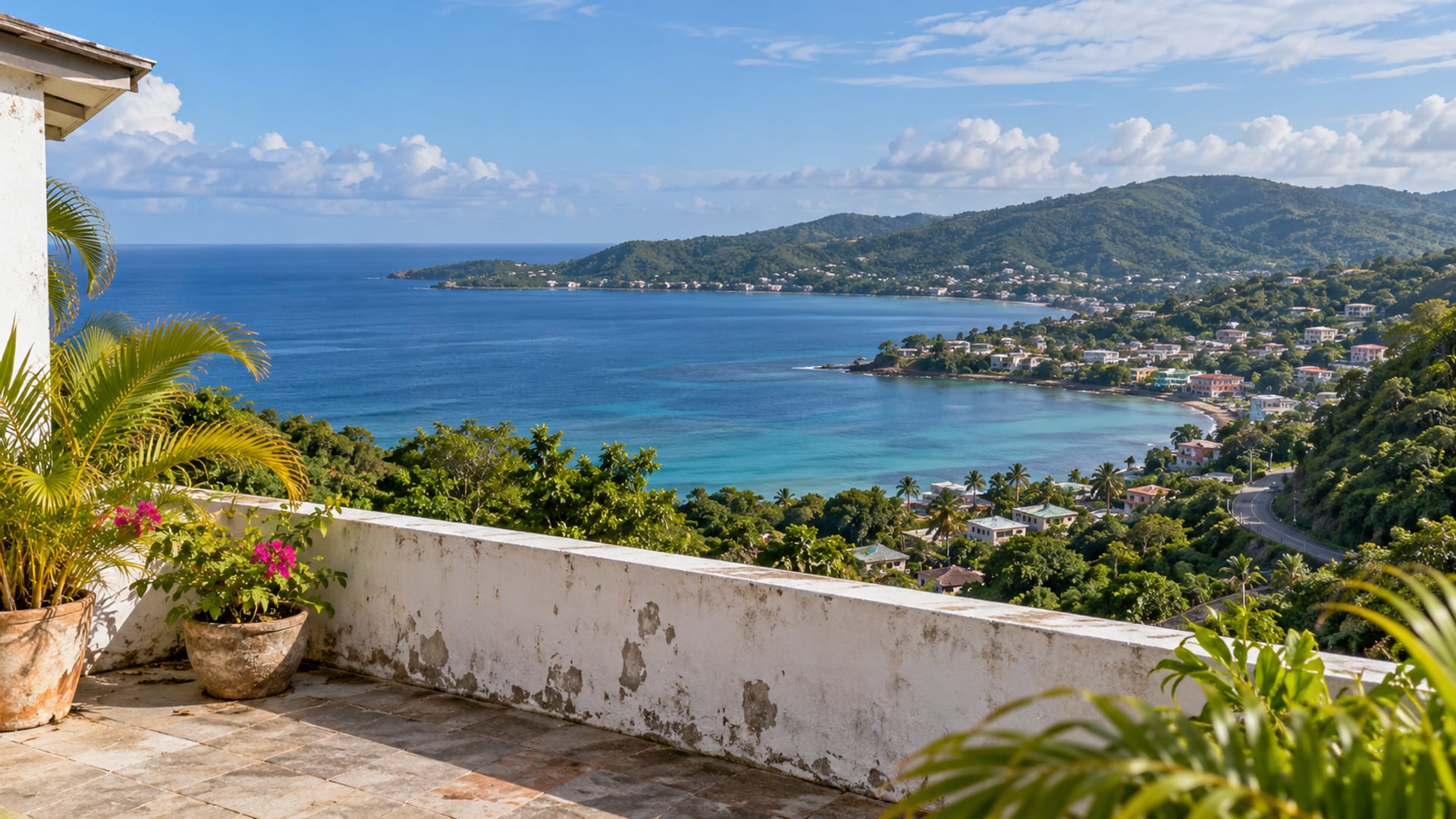 Hillside terrace overlooking a calm bay and a distant town in afternoon light
