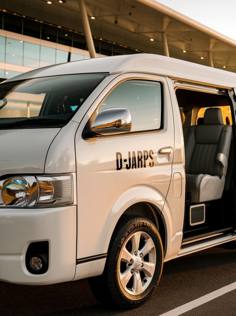 White Toyota HiAce shuttle van at Sangster International Airport's pickup area